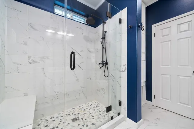 a bathroom with a shower and a sink