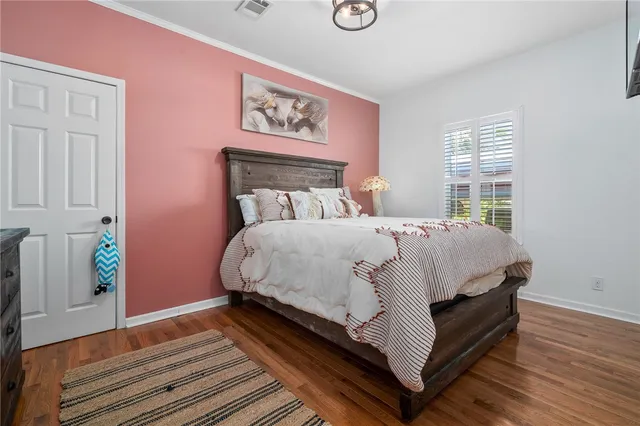 a bed sitting in a bedroom next to a window