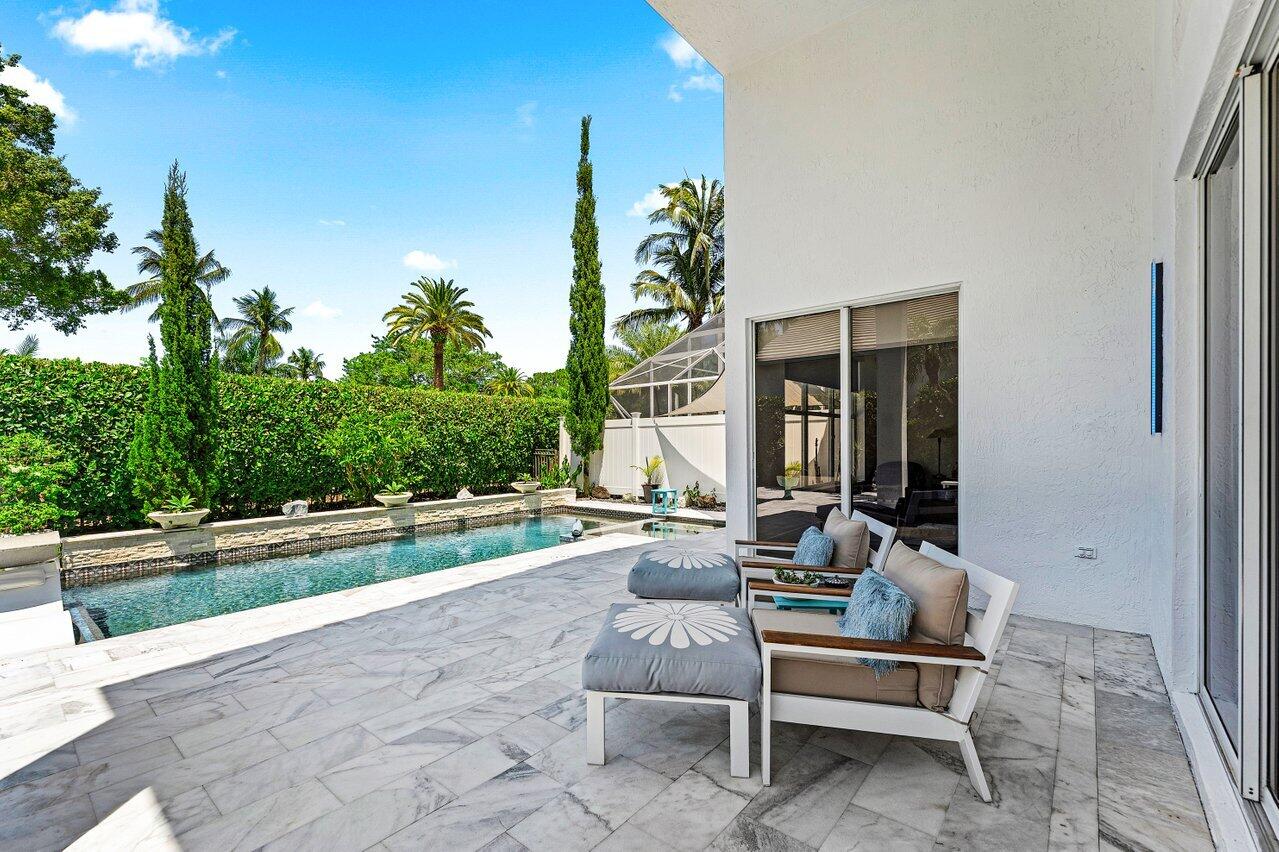3395 Northwest 53rd Circle Boca Raton, FL 33496 - Photo 23 of 64 a living room with patio furniture and a garden