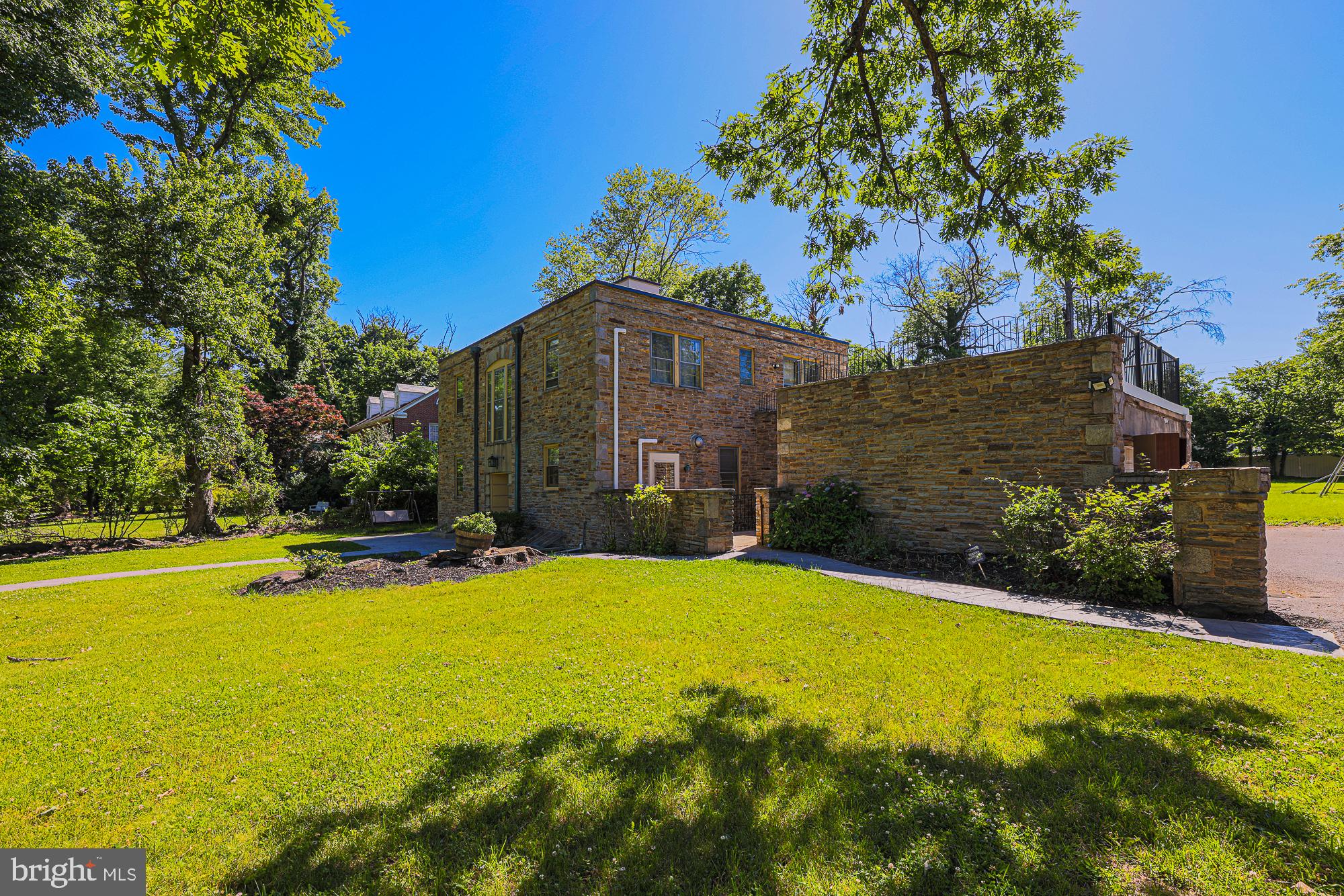 3305 Bancroft Road Baltimore, MD 21215 - Photo 18 of 61 Modern stone home amidst lush greenery.