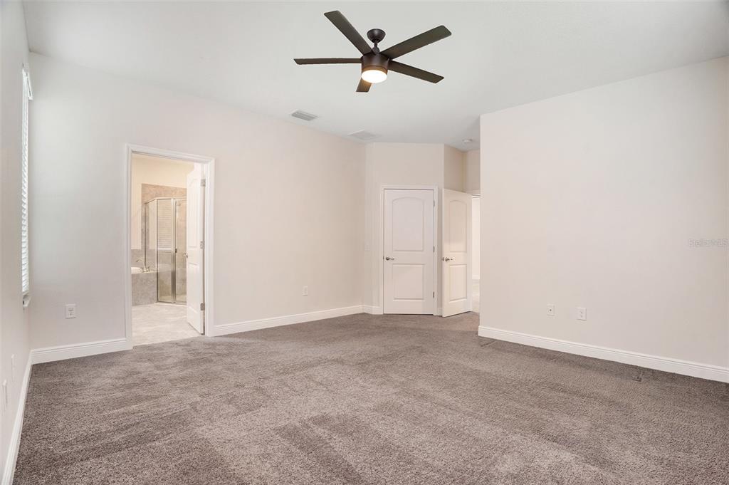 12330 Newt Court New Port Richey, FL 34654 - Photo 16 of 30 an empty room with a ceiling fan and window