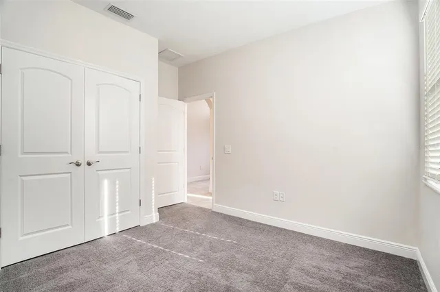 a bathroom with a granite countertop sink a toilet a mirror a bathtub and shower