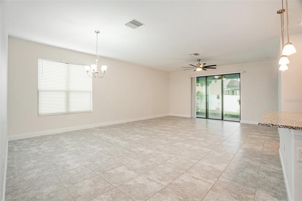 12330 Newt Court New Port Richey, FL 34654 - Photo 5 of 30 an empty room with windows and chandelier fan