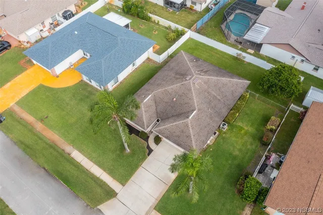 an aerial view of a house with a swimming pool