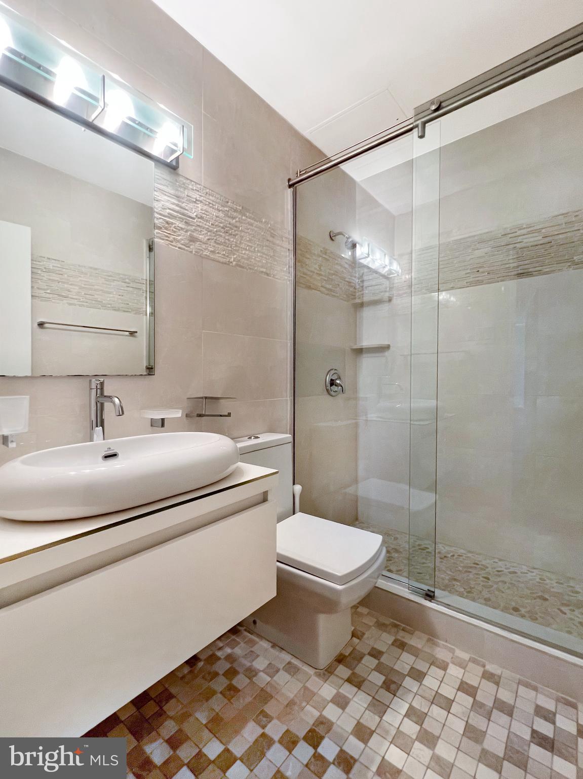 2475 Virginia Avenue Northwest, Unit 917 Washington, DC 20037 - Photo 11 of 21 a bathroom with a sink toilet and shower