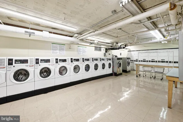 a utility room with stainless steel appliances and cabinets