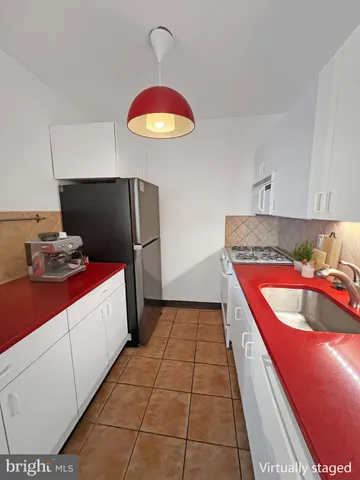 a kitchen with a sink a stove and refrigerator