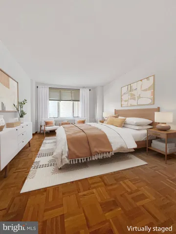 a large bedroom with a bed and window