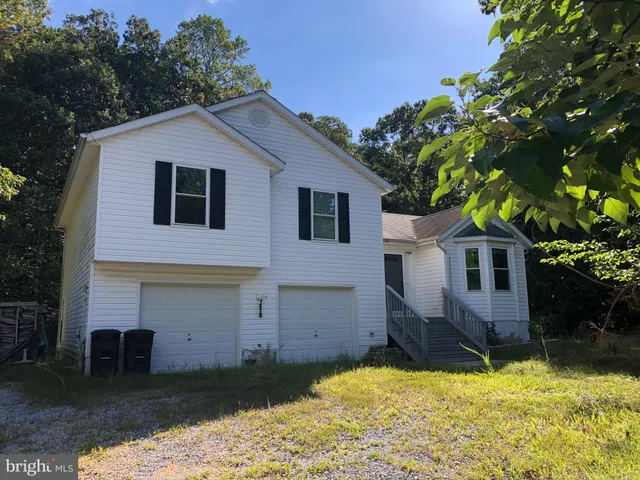 a house that has a tree in front of it