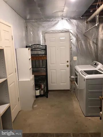 a view of a storage & utility room with washer and dryer