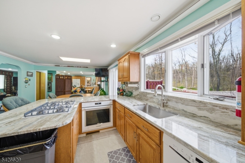 42 Schoolhouse Road Randolph, NJ 07869 - Photo 13 of 49 a kitchen with stainless steel appliances granite countertop a sink stove and cabinets