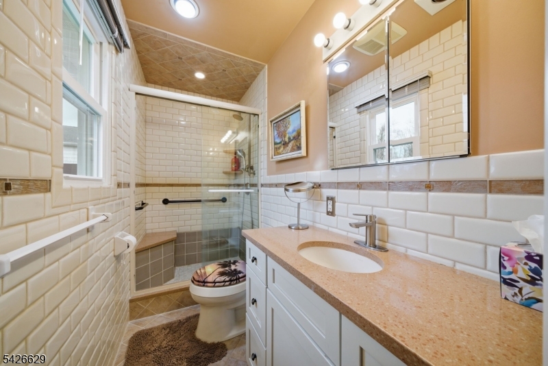 42 Schoolhouse Road Randolph, NJ 07869 - Photo 16 of 49 a bathroom with a granite countertop sink mirror vanity and toilet