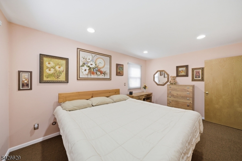 42 Schoolhouse Road Randolph, NJ 07869 - Photo 18 of 49 a bedroom with a large bed and a table