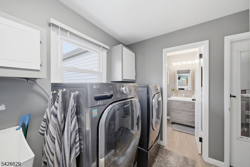 42 Schoolhouse Road Randolph, NJ 07869 - Photo 24 of 49 a utility room with wooden floor washer and dryer