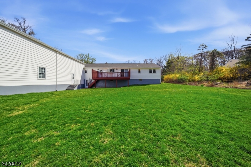 42 Schoolhouse Road Randolph, NJ 07869 - Photo 41 of 49 a view of a house with a yard and sitting area