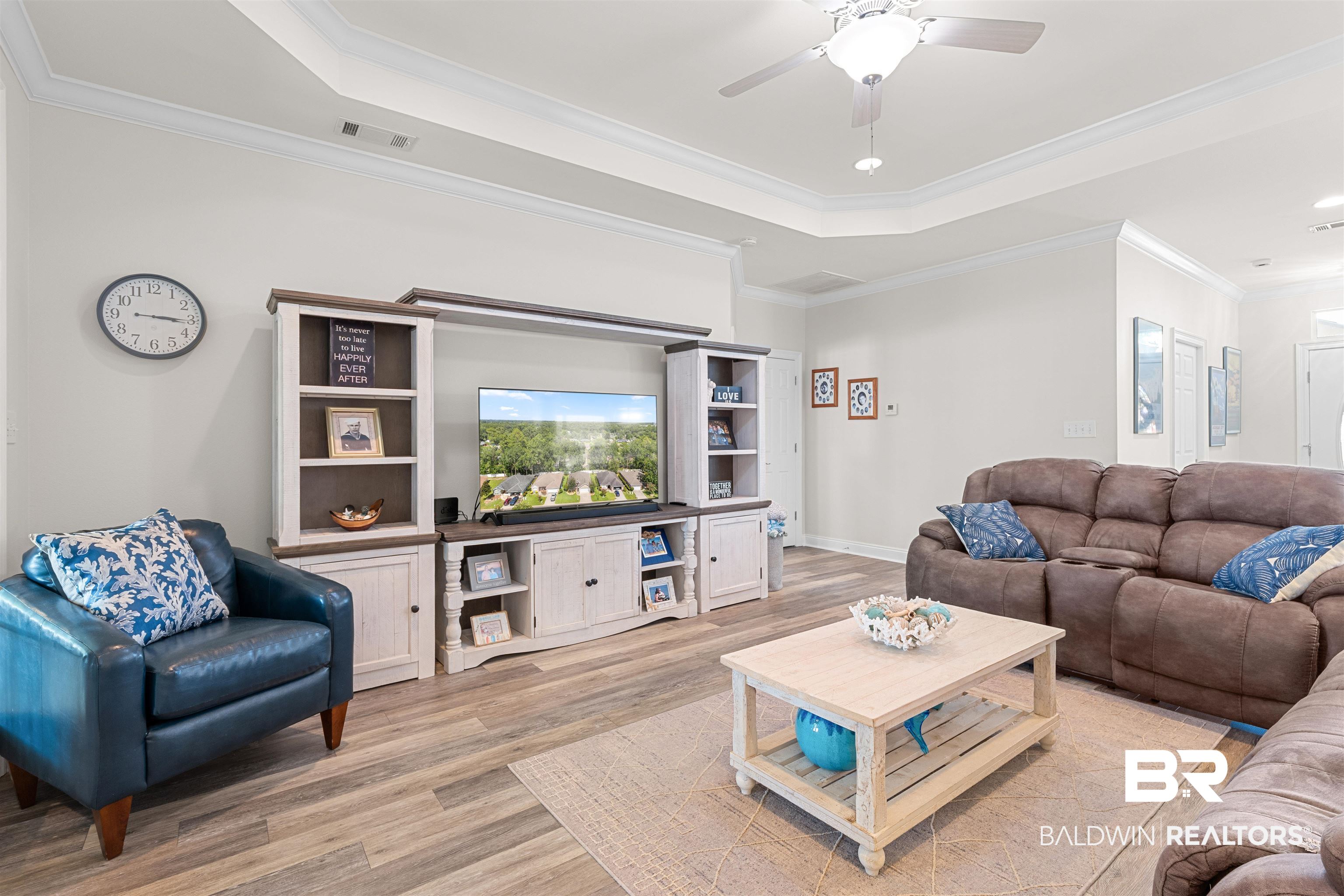 141 Mark Twain Loop Foley, AL 36535 - Photo 12 of 55 Living area with a tray ceiling, light wood-style floors, a ceiling fan, ornamental molding, and recessed lighting
