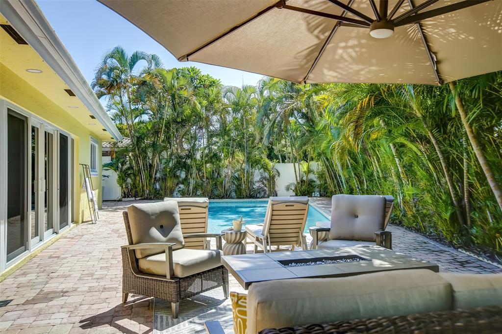 2600 North Riverside Drive Pompano Beach, FL 33062 - Photo 16 of 25 a outdoor sitting area with chairs and wooden fence