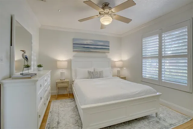 a spacious bedroom with a bed and a chandelier