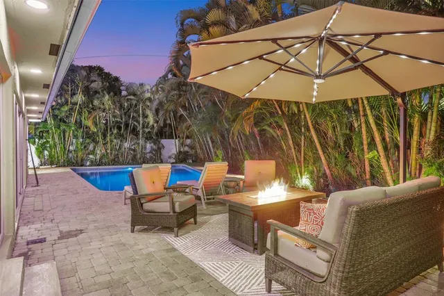 a view of a backyard with a patio and outdoor seating