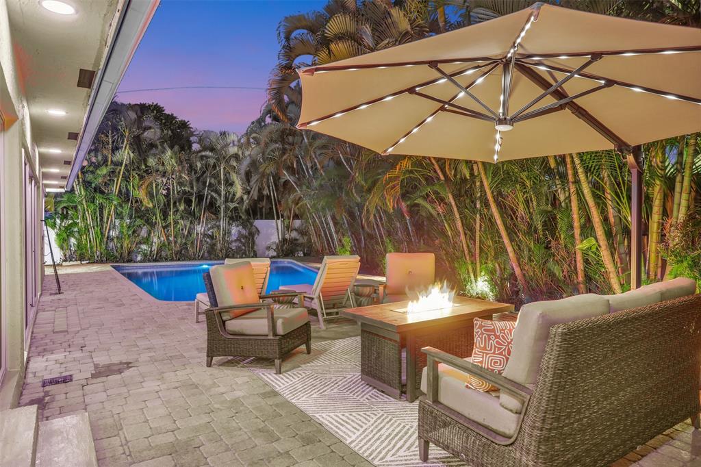 2600 North Riverside Drive Pompano Beach, FL 33062 - Photo 2 of 25 a view of a backyard with a patio and outdoor seating