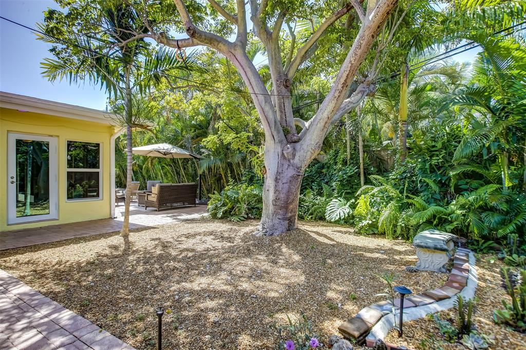 2600 North Riverside Drive Pompano Beach, FL 33062 - Photo 23 of 25 a view of a house with backyard sitting area and garden