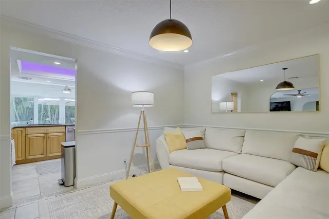a living room with a couch and chandelier