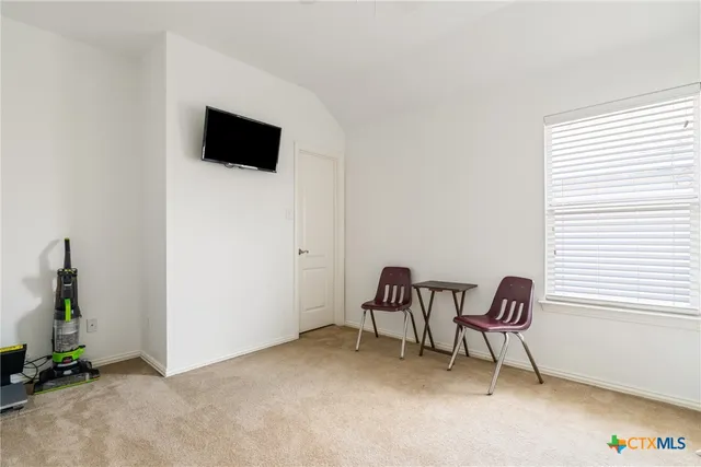 a view of work space with furniture and windows