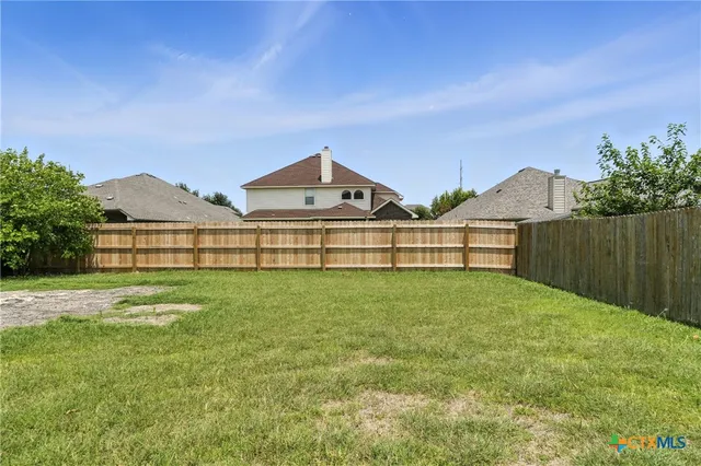 a view of a house with a yard and sitting area