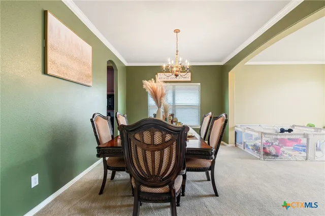 a dining room with furniture and window