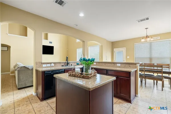 a kitchen with stainless steel appliances granite countertop a sink and a stove