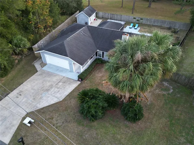 an aerial view of a house with a yard