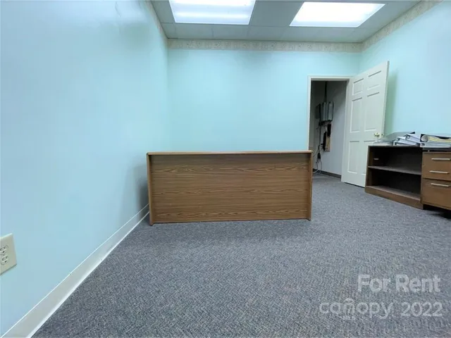 a view of an empty room with a fireplace