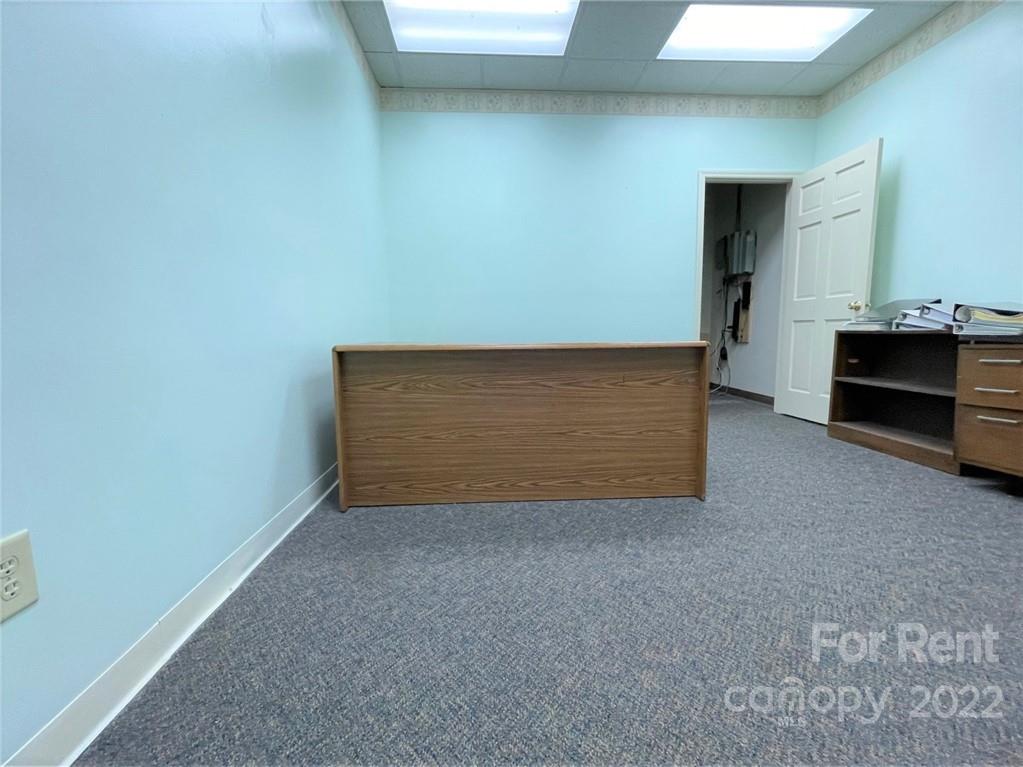201 West Morgan Street, Unit B Wadesboro, NC 28170 - Photo 5 of 14 a view of an empty room with a fireplace
