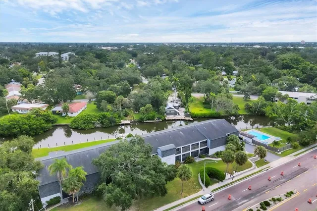 an aerial view of residential houses with outdoor space and street view