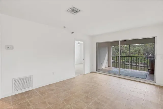 a view of a big room with wooden cabinet and a kitchen