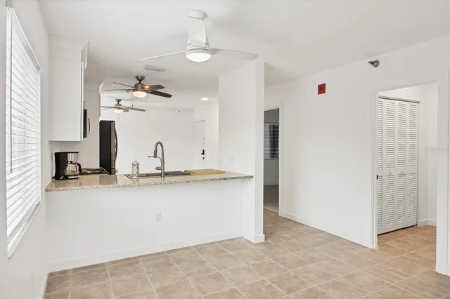 a kitchen with stainless steel appliances cabinets a microwave and a refrigerator
