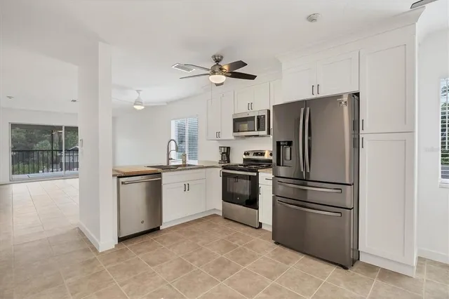 a kitchen with stainless steel appliances granite countertop a sink and a stove