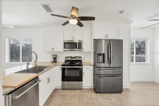 a view of a livingroom with a ceiling fan and window