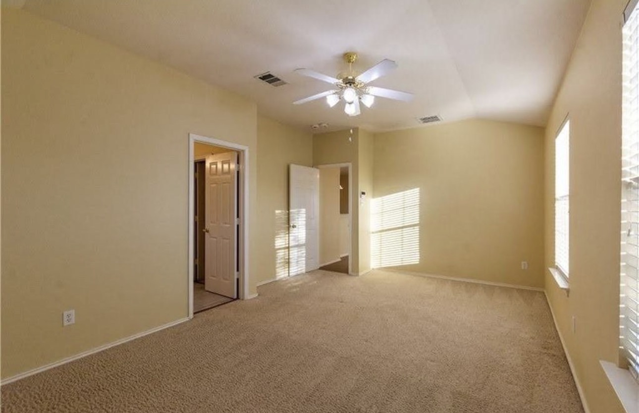 1900 Scofield Ridge Parkway, Unit 3101 Austin, TX 78727 - Photo 11 of 24 Carpeted interior space featuring neutral wall tones, vaulted ceilings, and a ceiling fan with integrated lighting