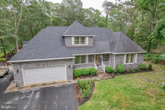 a aerial view of a house next to a yard