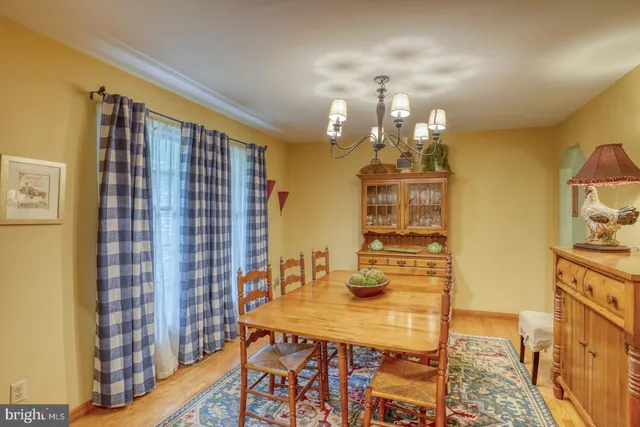 a view of a dining room with furniture and chandelier