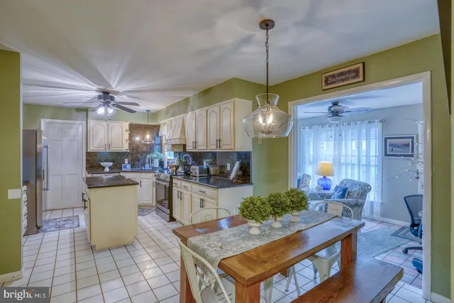 a kitchen with stainless steel appliances kitchen island granite countertop a stove a sink and a refrigerator