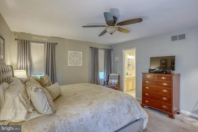 a bedroom with a bed and a tv on the dresser
