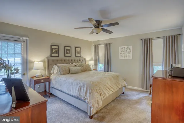 a bedroom with a bed and flat tv screen on the dresser