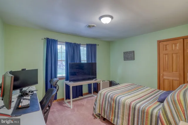 a bedroom with a bed and a desk