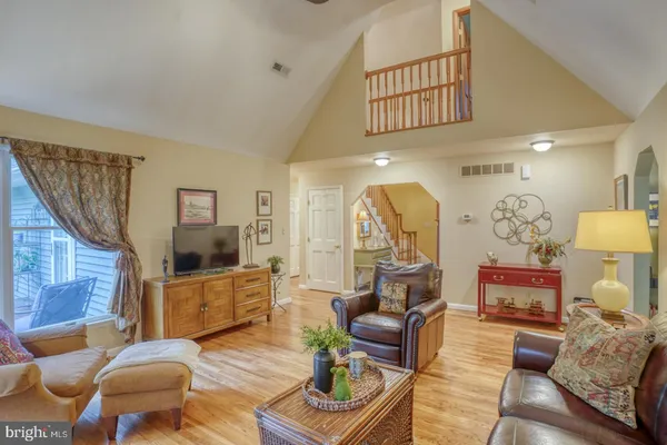 a living room with fireplace furniture and a wooden floor