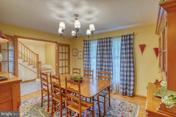 a view of a dining room with furniture and chandelier