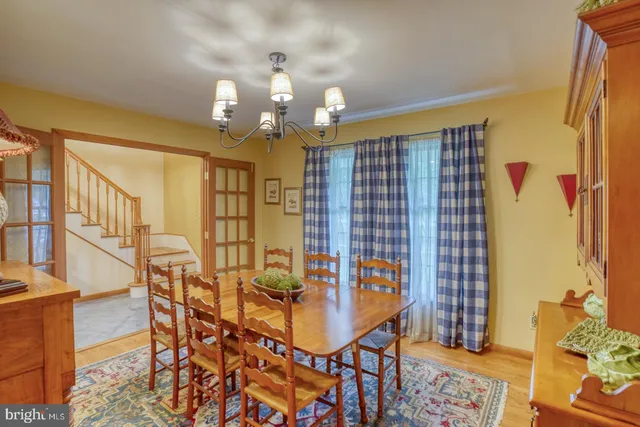 a view of a dining room with furniture and chandelier