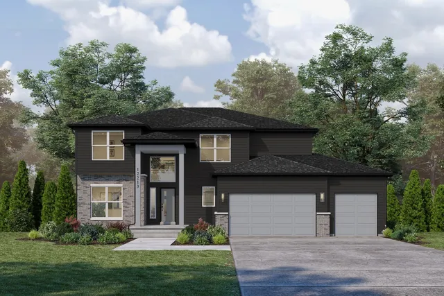 a front view of a house with a yard and trees