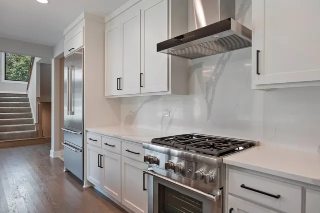 a stove top oven sitting inside of a kitchen